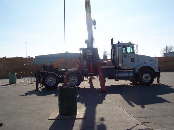 ball_in_barrels Crane placing overhead ball in two barrels