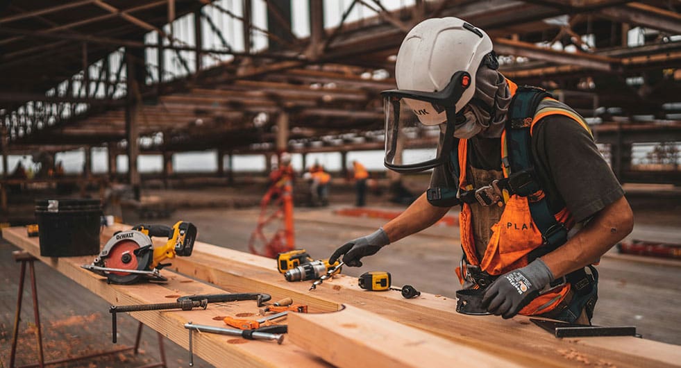 General Industry - worker preparing for light construction with tools